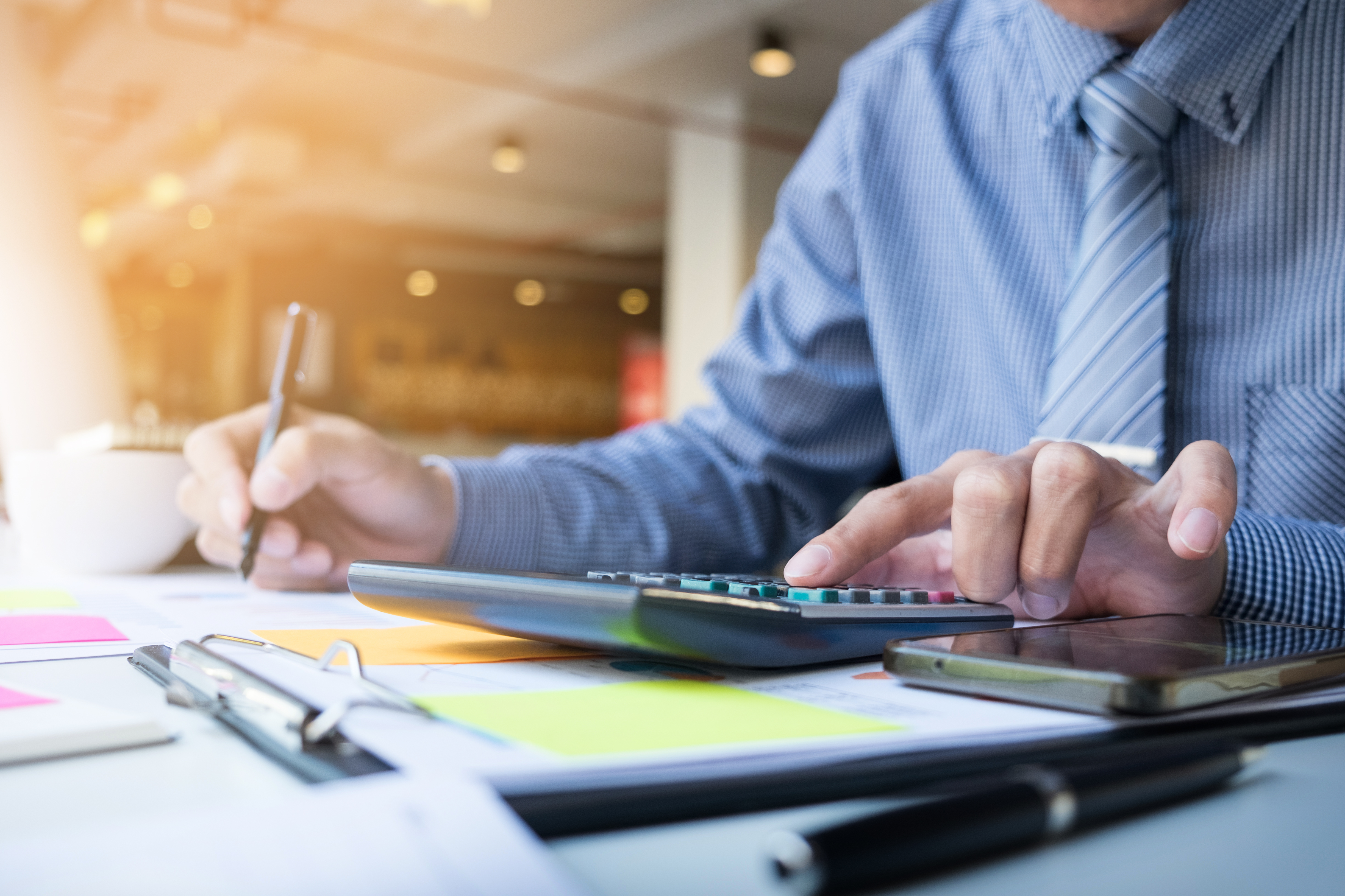 Business finance man calculating budget numbers, Invoices and financial adviser working.